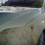 Before and after photographs of a damaged white, AUDI Quattro SUV that was repaired by Elite Paint & Body Shop in West Palm Beach, Florida.